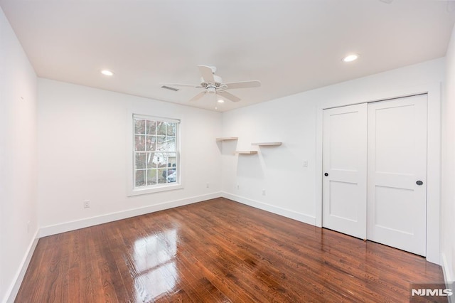 unfurnished bedroom with baseboards, a closet, wood finished floors, and recessed lighting