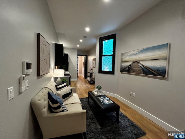 living room with wood finished floors, baseboards, vaulted ceiling, and recessed lighting
