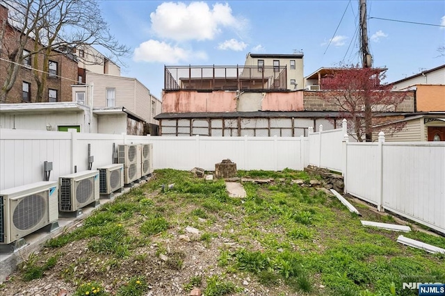 view of yard with a fenced backyard and ac unit