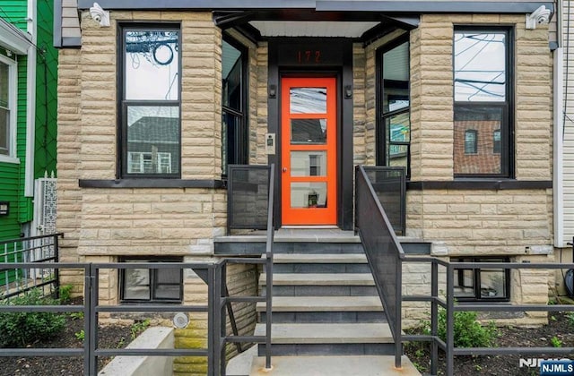property entrance featuring stone siding
