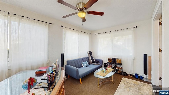 living room featuring carpet floors and ceiling fan