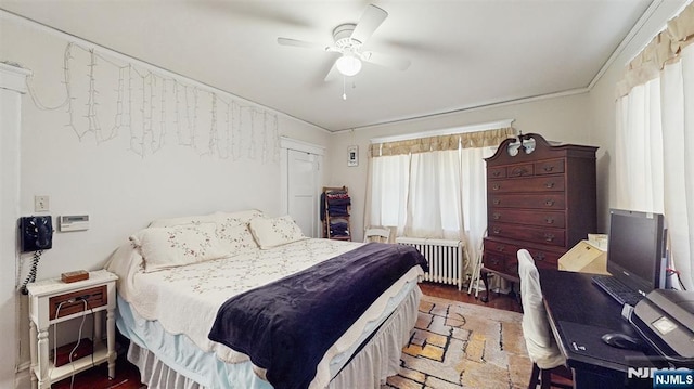 bedroom with radiator and a ceiling fan