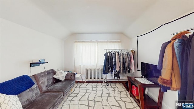 interior space with radiator and vaulted ceiling