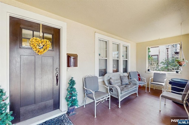 doorway to property featuring stucco siding