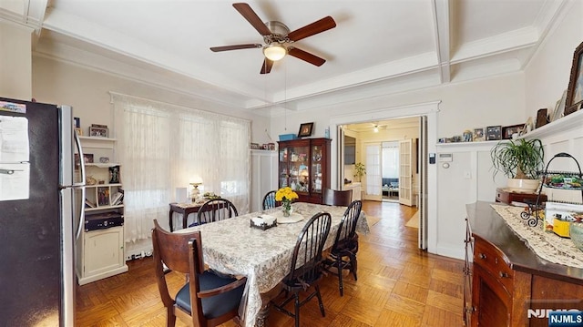 dining space featuring a ceiling fan, crown molding, and beamed ceiling