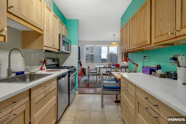 2000 Linwood Ave Unit 12S, Fort Lee, NJ 07024 - kitchen featuring appliances with stainless steel finishes, a sink, decorative backsplash, light countertops, and pendant lighting