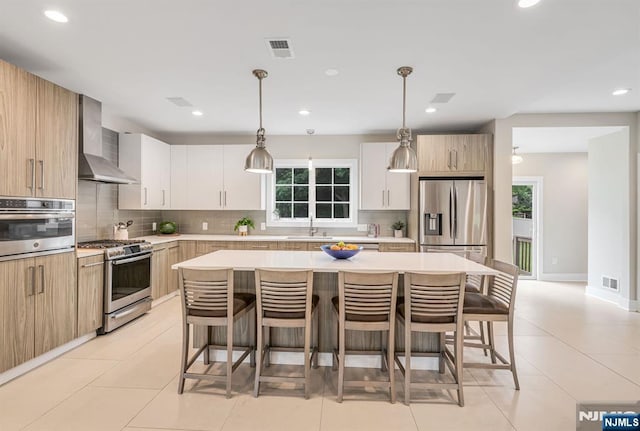 334 Durie Ave, Closter, NJ 07624 - kitchen featuring appliances with stainless steel finishes, wall chimney range hood, a breakfast bar area, tasteful backsplash, and recessed lighting