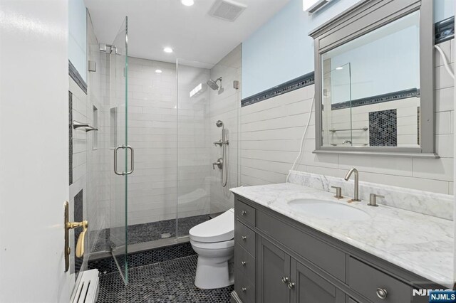 bathroom with vanity, visible vents, toilet, recessed lighting, and a shower stall