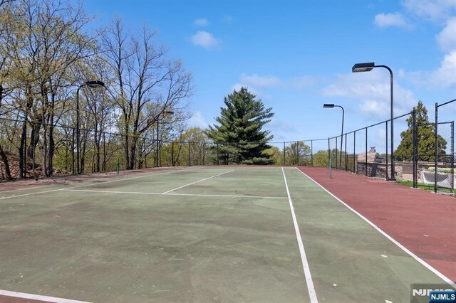 view of sport court featuring fence