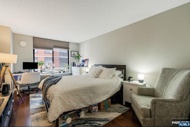 bedroom with hardwood / wood-style flooring and a textured ceiling