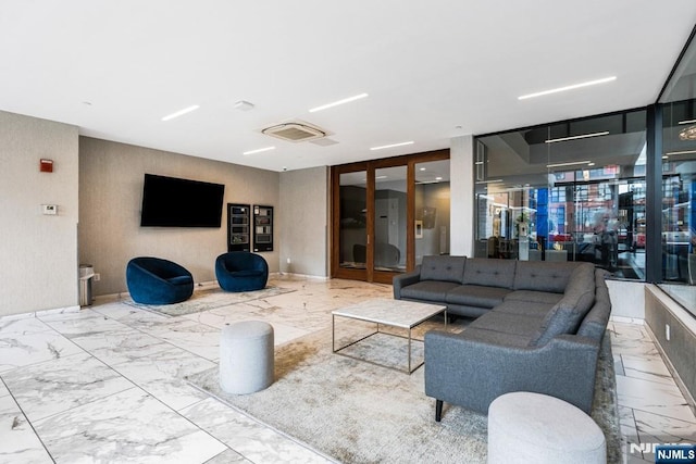 living room featuring marble finish floor and baseboards