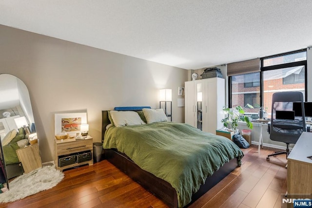bedroom with wood finished floors and a textured ceiling