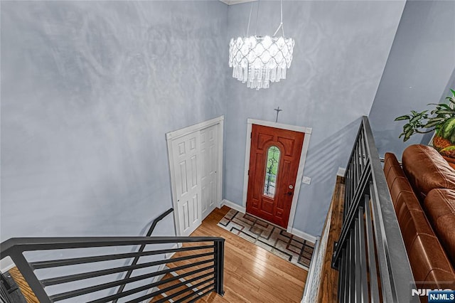 55 N Hillside Ave, Roxbury Township, NJ 07847 - foyer featuring a chandelier, wood-type flooring, a high ceiling, and baseboards