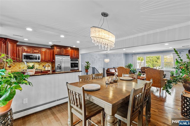 55 N Hillside Ave, Roxbury Township, NJ 07847 - dining space featuring visible vents, a notable chandelier, ornamental molding, light wood-style floors, and a baseboard heating unit