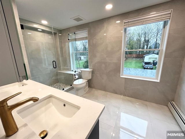 126 Closter Dock Rd, Closter, NJ 07624 - bathroom with a baseboard radiator, toilet, tile walls, a stall shower, and vanity