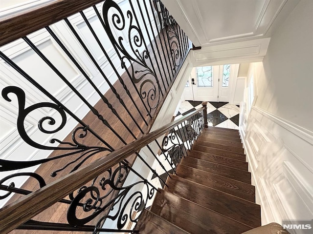 126 Closter Dock Rd, Closter, NJ 07624 - stairway featuring french doors, wainscoting, and a decorative wall