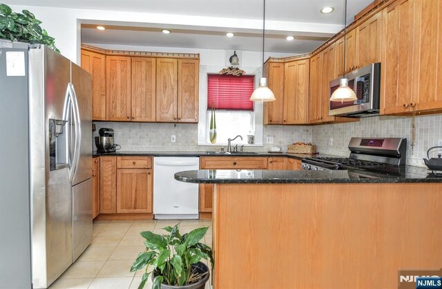 279 Boonton Ave, Butler Borough, NJ 07405 - kitchen featuring a peninsula, tasteful backsplash, appliances with stainless steel finishes, and light tile patterned floors