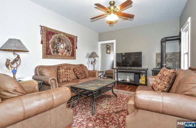 279 Boonton Ave, Butler Borough, NJ 07405 - living room featuring ceiling fan, a wood stove, and wood finished floors