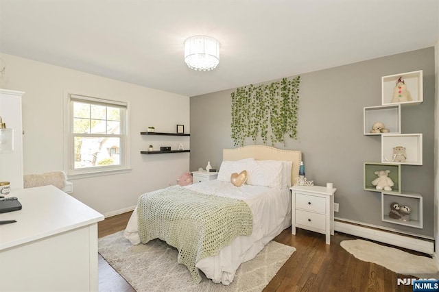 bedroom with baseboard heating, baseboards, and dark wood-style floors