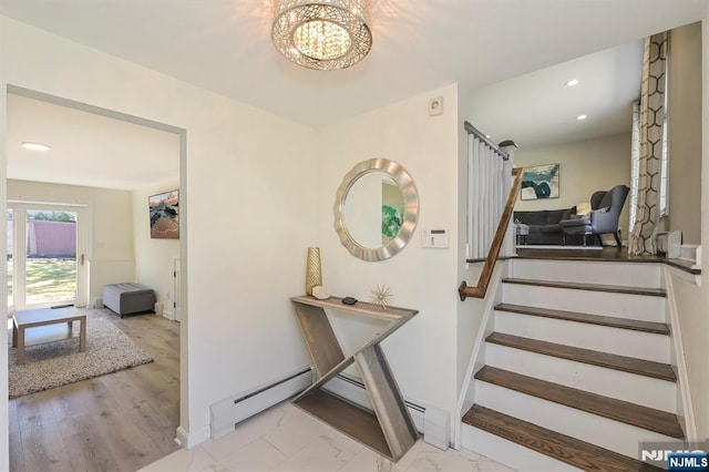 stairway featuring a chandelier, a baseboard heating unit, baseboards, and recessed lighting