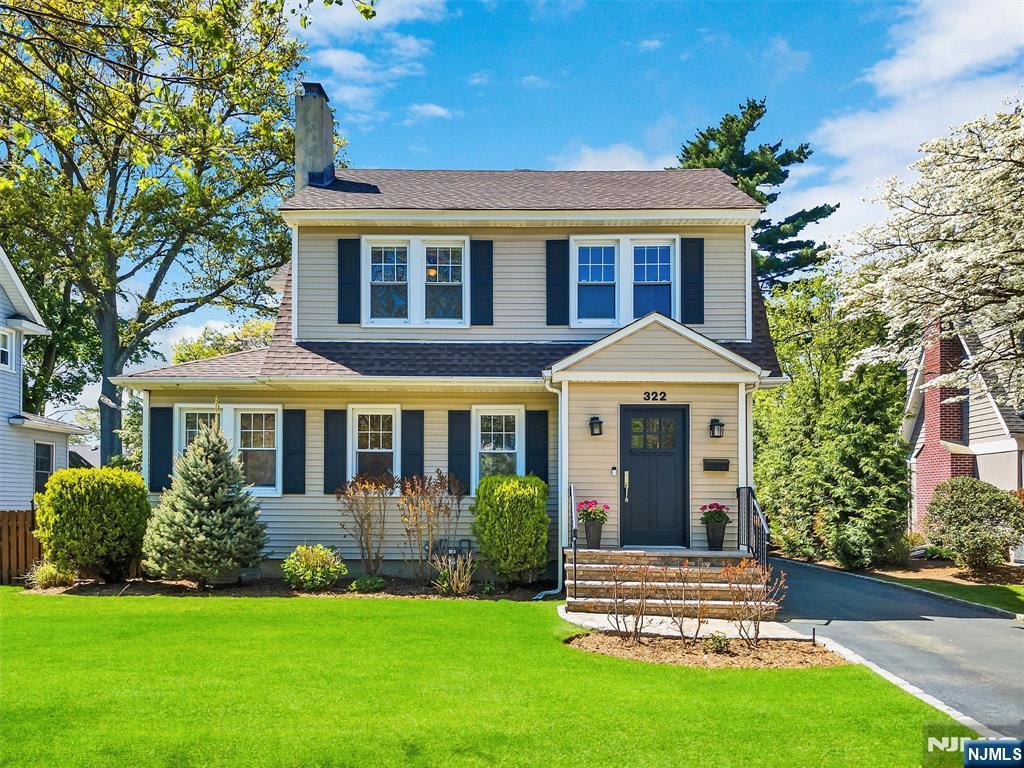 322 Fairfield Ave, Ridgewood, NJ 07450 - view of front facade featuring a chimney, a shingled roof, and a front lawn