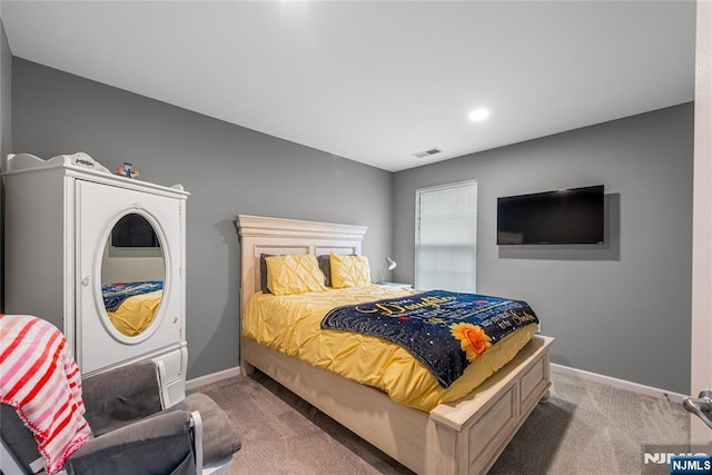 carpeted bedroom with visible vents and baseboards