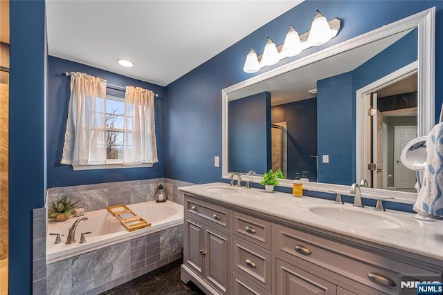 full bath featuring walk in shower, double vanity, a garden tub, and a sink