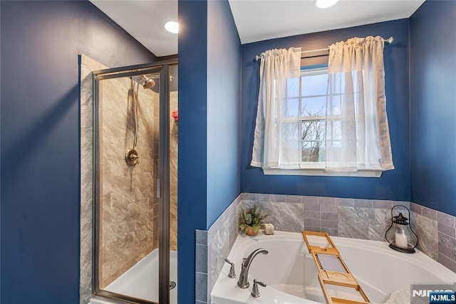 full bath featuring a shower stall and a garden tub