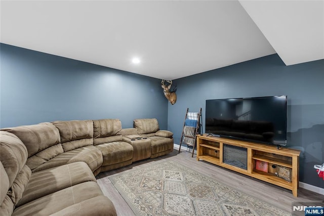 living room with baseboards and wood finished floors