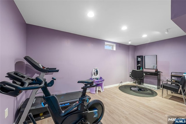 workout room with baseboards, recessed lighting, and wood finished floors