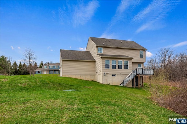 back of property featuring stairs, a deck, and a yard