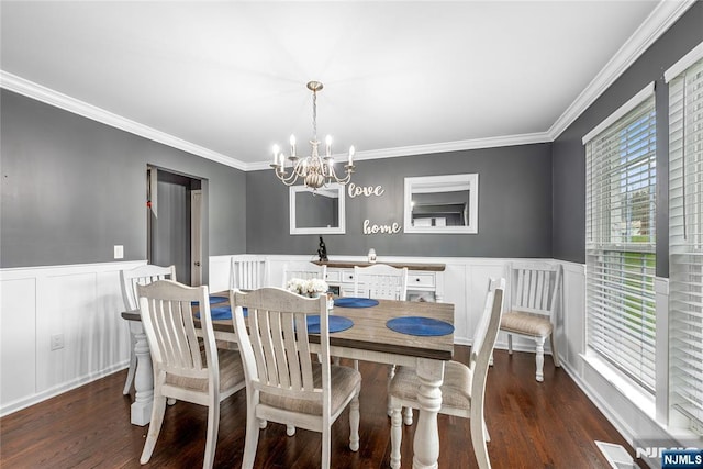 dining space with visible vents, wainscoting, a notable chandelier, and wood finished floors