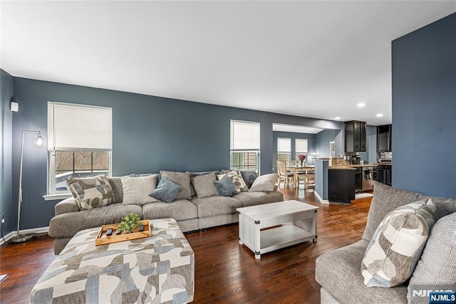 living area featuring recessed lighting, baseboards, and dark wood finished floors