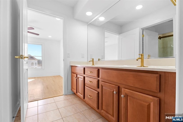 full bath featuring recessed lighting, double vanity, a sink, and tile patterned flooring