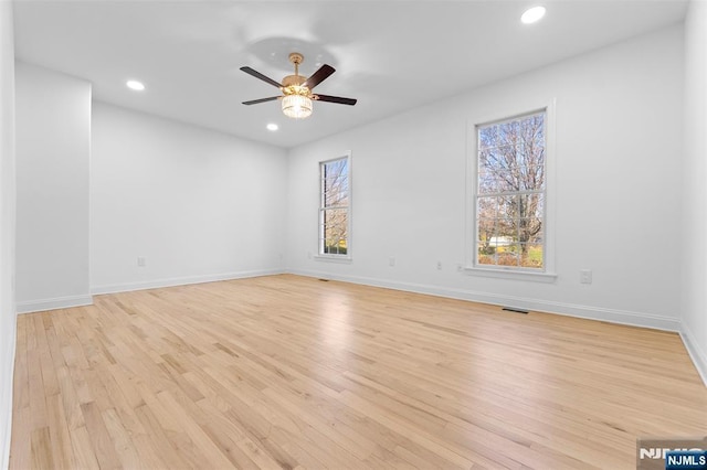 unfurnished room with light wood finished floors, recessed lighting, ceiling fan, and plenty of natural light