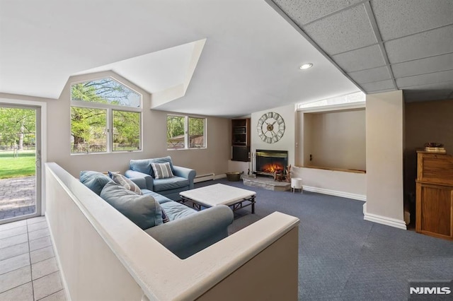 living area featuring baseboards, baseboard heating, a lit fireplace, recessed lighting, and vaulted ceiling