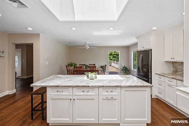 kitchen with freestanding refrigerator, recessed lighting, and visible vents