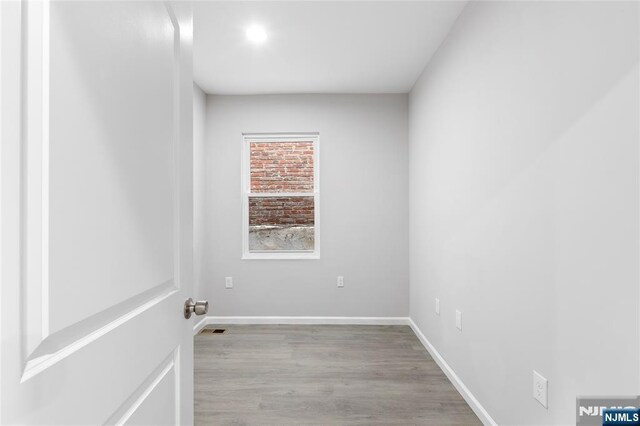 1457 67th St, North Bergen, NJ 07047 - empty room featuring visible vents, baseboards, and wood finished floors