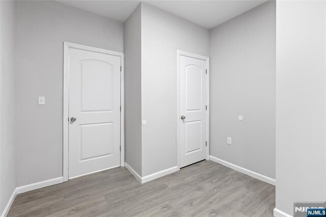 1457 67th St, North Bergen, NJ 07047 - unfurnished bedroom with light wood-style flooring and baseboards