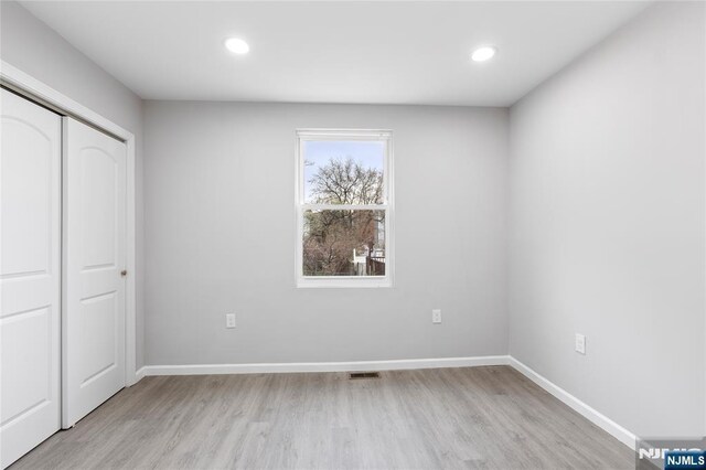 1457 67th St, North Bergen, NJ 07047 - unfurnished bedroom featuring visible vents, baseboards, a closet, and light wood-style floors