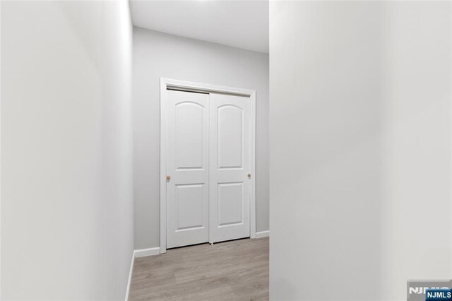 1457 67th St, North Bergen, NJ 07047 - hall with light wood-style flooring and baseboards