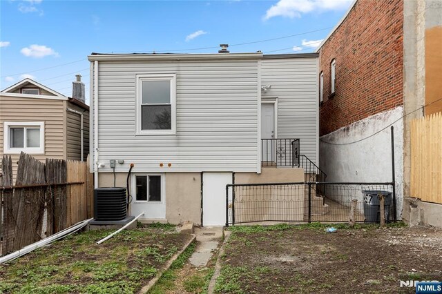 1457 67th St, North Bergen, NJ 07047 - rear view of property featuring central air condition unit and fence