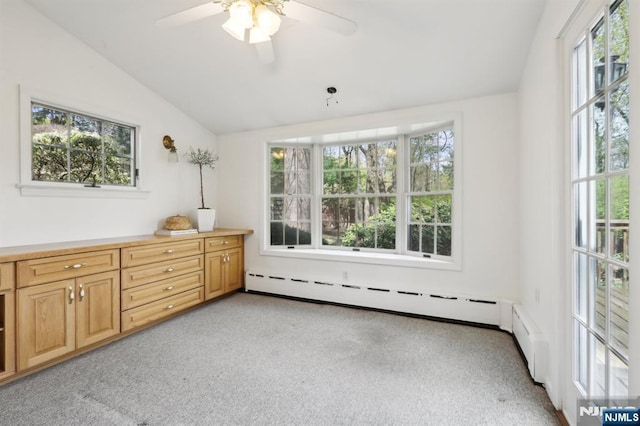 bedroom with a ceiling fan, baseboard heating, vaulted ceiling, and light carpet