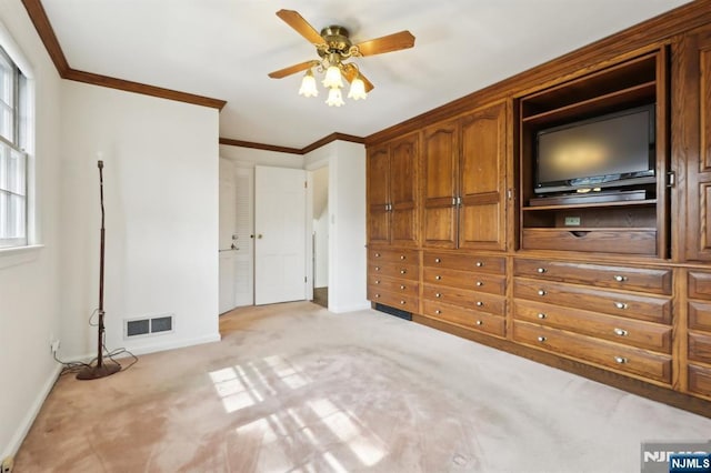 unfurnished bedroom featuring crown molding, baseboards, multiple windows, and light colored carpet