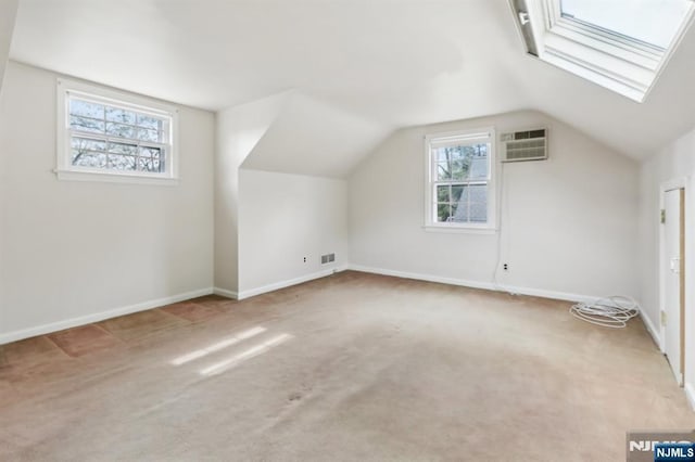bonus room with carpet floors, baseboards, an AC wall unit, and lofted ceiling