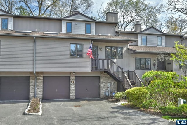9 Peach Hill Ct, Ramsey, NJ 07446 - multi unit property with a chimney, an attached garage, asphalt driveway, and brick siding