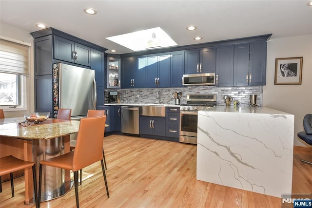9 Peach Hill Ct, Ramsey, NJ 07446 - kitchen with stainless steel appliances, a sink, tasteful backsplash, light stone counters, and glass insert cabinets