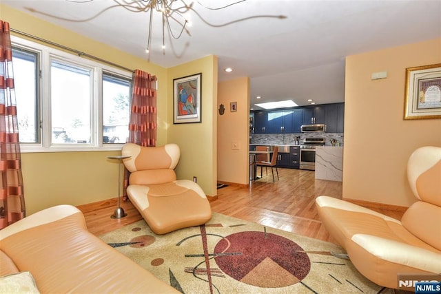 9 Peach Hill Ct, Ramsey, NJ 07446 - living room featuring light wood-style floors, baseboards, recessed lighting, and a chandelier