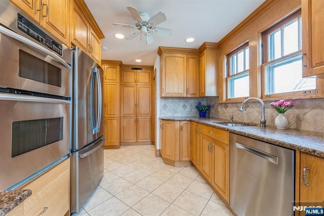 kitchen with appliances with stainless steel finishes, decorative backsplash, recessed lighting, and a sink