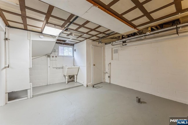 below grade area featuring concrete block wall